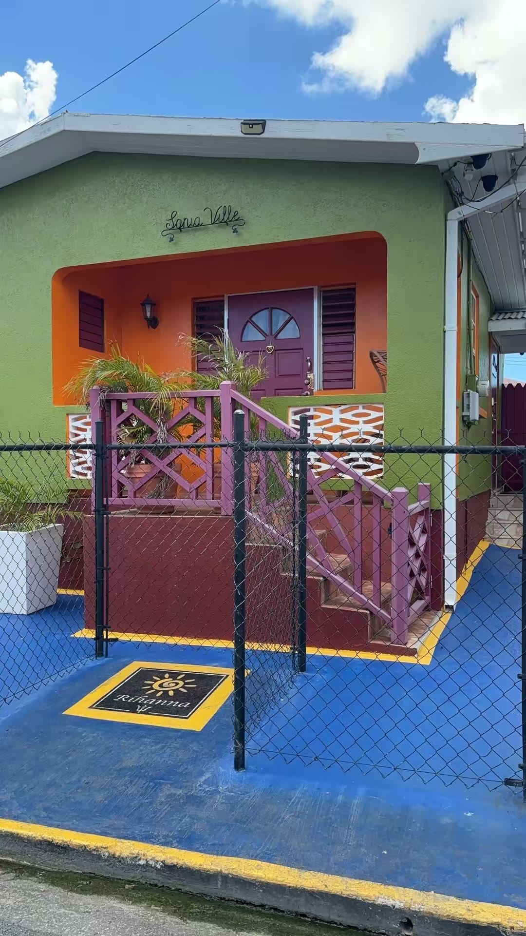 The brightly painted green and orange childhood home of Rihanna on Westbury Road, Barbados
